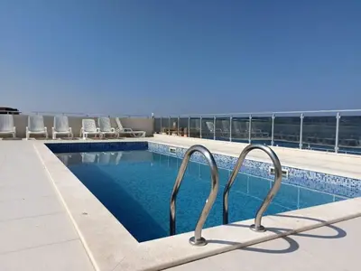 a swimming pool on the roof of a building at Apartments Meri in Dobra Voda