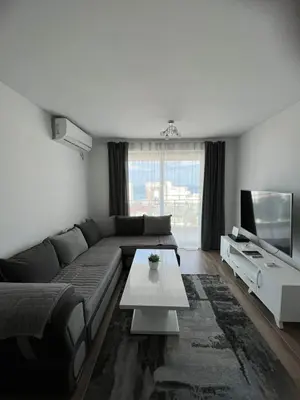 a living room with a couch and a tv at Apartments Meri in Dobra Voda