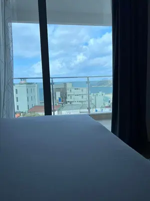 a room with a window with a view of a city at Apartments Meri in Dobra Voda