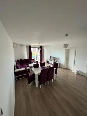 a living room with a couch and a table and chairs at Apartments Meri in Dobra Voda
