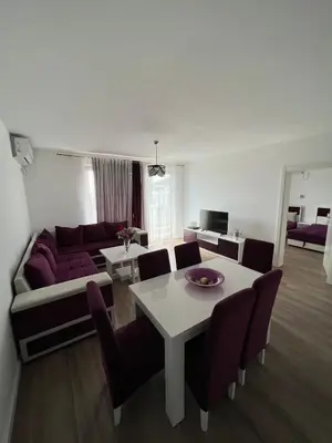 a living room with a couch and a table with chairs at Apartments Meri in Dobra Voda