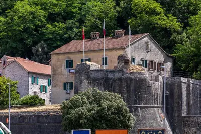 a house sitting on top of a stone wall at Vincenza Apartment in Kotor