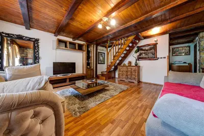 a living room with a couch and a tv at Vincenza Apartment in Kotor