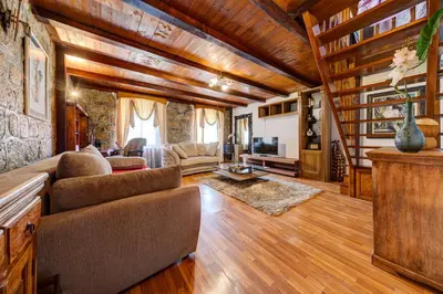 a living room with a couch and a tv at Vincenza Apartment in Kotor