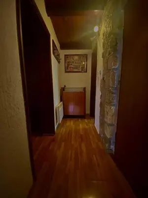 a hallway with a door and a stone wall at Vincenza Apartment in Kotor