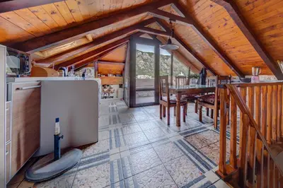 a kitchen and dining room with a table in a cabin at Vincenza Apartment in Kotor