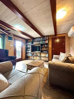 a living room with two couches and a table at Wooden House - Imanje Terzic in Podgorica