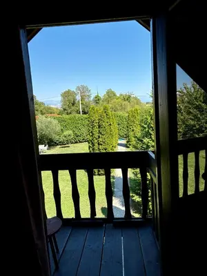 a door to a porch with a view of a yard at Wooden House - Imanje Terzic in Podgorica