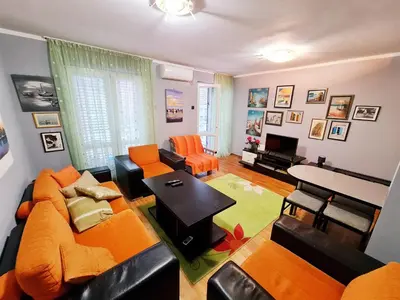 a living room with a couch and a table at Olimp lux III in Budva