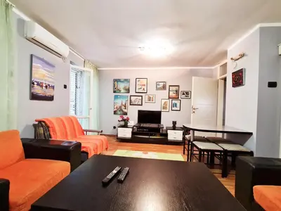 a living room with a couch and a table at Olimp lux III in Budva