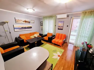 a living room with a couch and chairs and a table at Olimp lux III in Budva