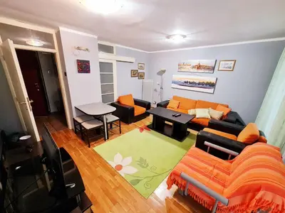 a living room with a couch and a table at Olimp lux III in Budva