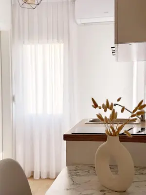 a white vase sitting on a counter in a kitchen at Danin apartmani in Bar
