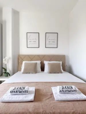 a bedroom with a bed with two pillows on it at Danin apartmani in Bar