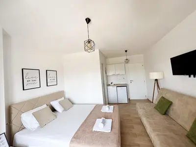 a living room with a bed and a couch at Danin apartmani in Bar