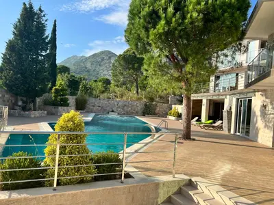 a villa with a swimming pool and mountains in the background at Villa Premium S in Bar
