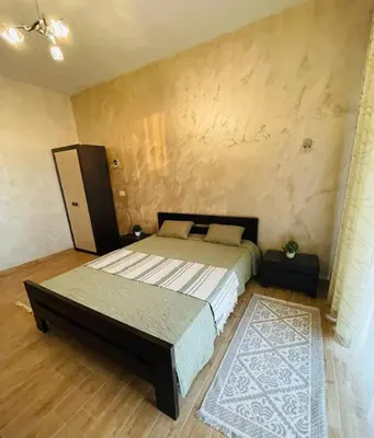 a bedroom with a large bed and a rug at Villa Premium S in Bar