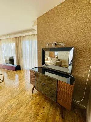 a living room with a dresser with a mirror on the wall at Villa Premium S in Bar