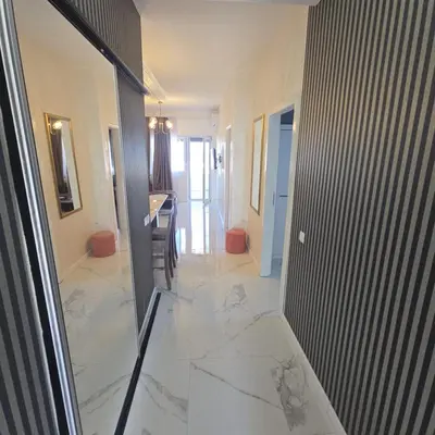 a hallway with a view of a living room and a kitchen at Apartmani Sunce in Bar