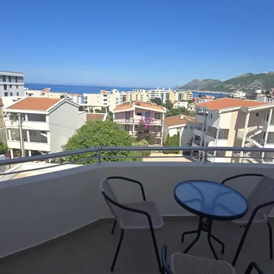 a balcony with chairs and a table on a balcony at Apartmani Sunce in Bar
