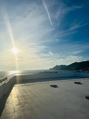 a view of the ocean with the sun in the sky at Apartmani Sunce in Bar