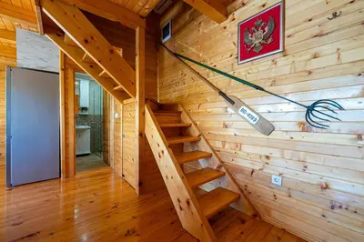 a staircase in a log cabin with a wooden wall at Villas Katarina Skadar Lake in Cetinje