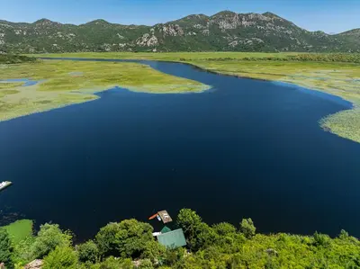 an aerial view of a lake with mountains in the background at Villas Katarina Skadar Lake in Cetinje