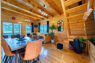 a dining room and living room of a log cabin at Villas Katarina Skadar Lake in Cetinje