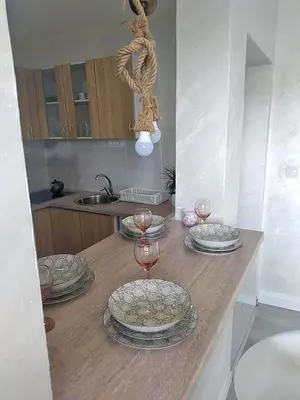 a table with plates and wine glasses on it at Harmony in Radanovići