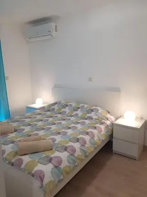 a bed in a room with two night stands at Apartment Andrea in Budva