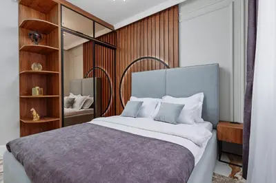 a bedroom with a large bed with wooden walls at Kotor Rooftop Apartments in Kotor