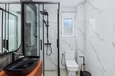 a bathroom with a black sink and a toilet at Kotor Rooftop Apartments in Kotor