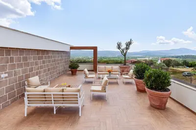 a patio with couches and chairs on a building at Kotor Rooftop Apartments in Kotor