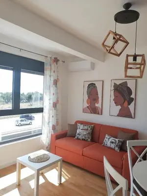 a living room with a red couch and a table at Vegi Apartments in Bar