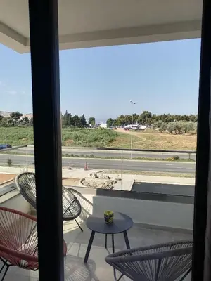 a balcony with chairs and a view of a beach at Vegi Apartments in Bar