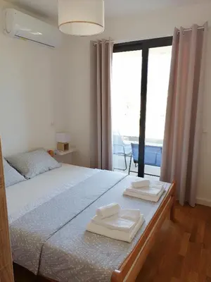 a bedroom with a bed with two towels on it at Vegi Apartments in Bar