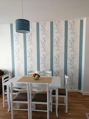 a dining room with a white table and chairs at Vegi Apartments in Bar