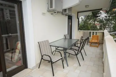 a patio with a table and chairs on a balcony at Apartment Jana in Petrovac na Moru