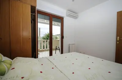 a bedroom with a bed with writing on it at Apartment Jana in Petrovac na Moru