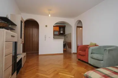 a living room with a couch and a kitchen at Apartment Jana in Petrovac na Moru