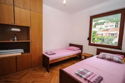 a room with two beds and a window at Apartment Jana in Petrovac na Moru