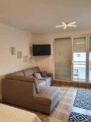 a living room with a couch and a flat screen tv at Apartman Bečiči - Budva - Free Parking in Budva