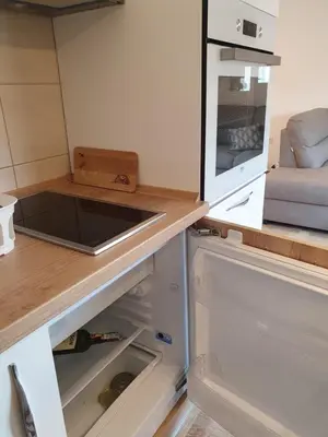 a kitchen with an open refrigerator with a sink at Apartman Bečiči - Budva - Free Parking in Budva
