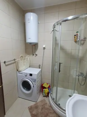 a bathroom with a washing machine and a shower at Apartman Bečiči - Budva - Free Parking in Budva
