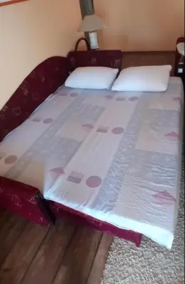 a bed in a bedroom with a bedspread on it at Village house Iva in Virpazar