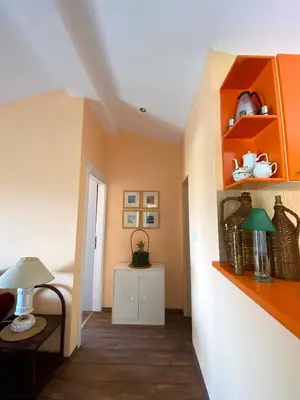 a room with orange shelves and a table with a lamp at Village house Iva in Virpazar