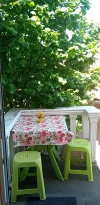 a picnic table and two stools on a porch at Village house Iva in Virpazar