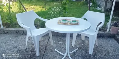 two white chairs and a table with two cups on it at Village house Iva in Virpazar
