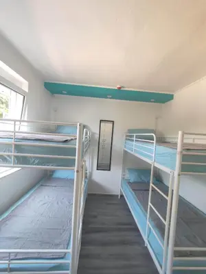 a room with three bunk beds and a window at SOVA smart HOUSE in Bar