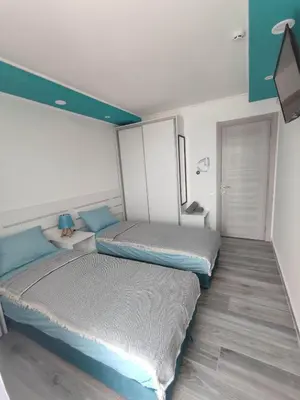 two beds in a room with blue and white at SOVA smart HOUSE in Bar